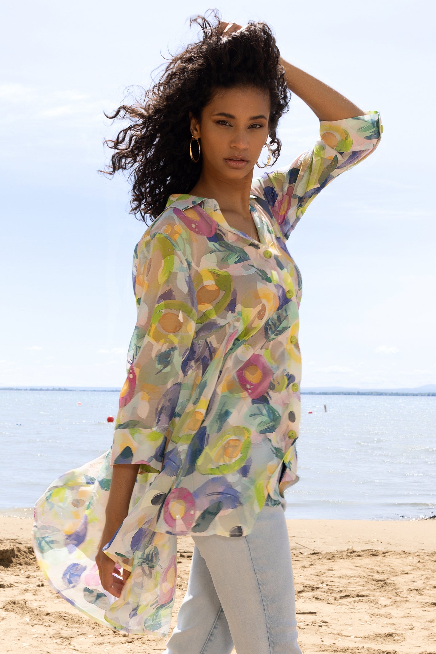 Woman wearing a colorful floral dress on a beach