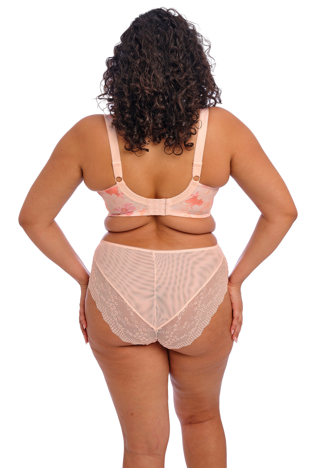 Woman wearing a beige bra and panties set on a white background