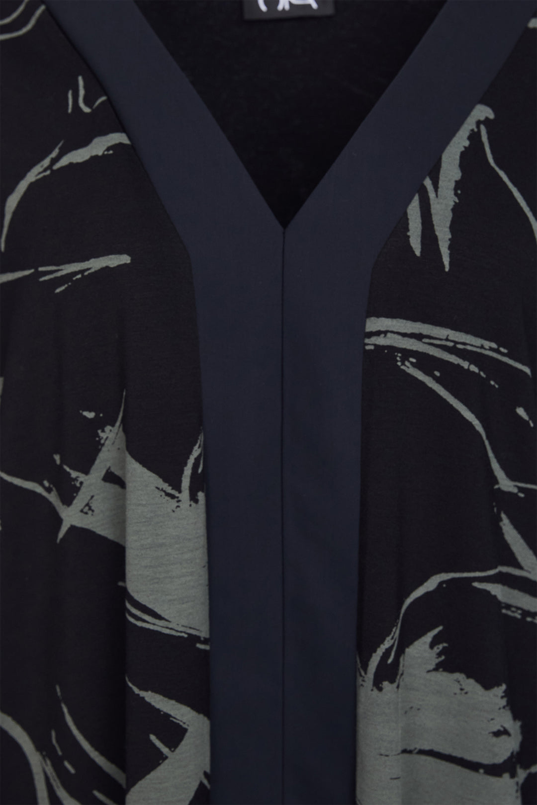 Black garment with green abstract patterns on a black background
