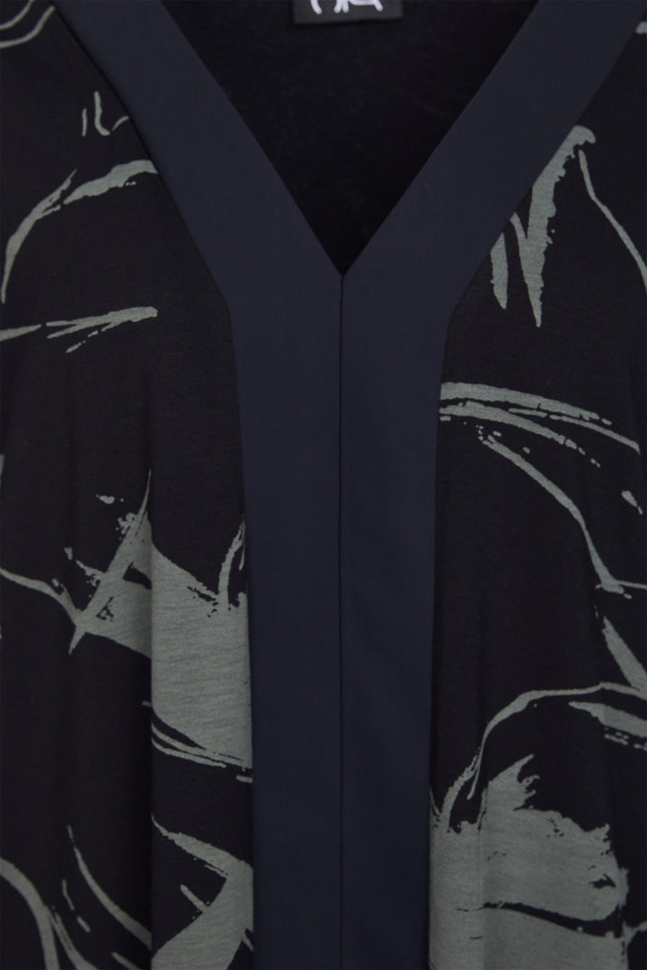 Black garment with green abstract patterns on a black background