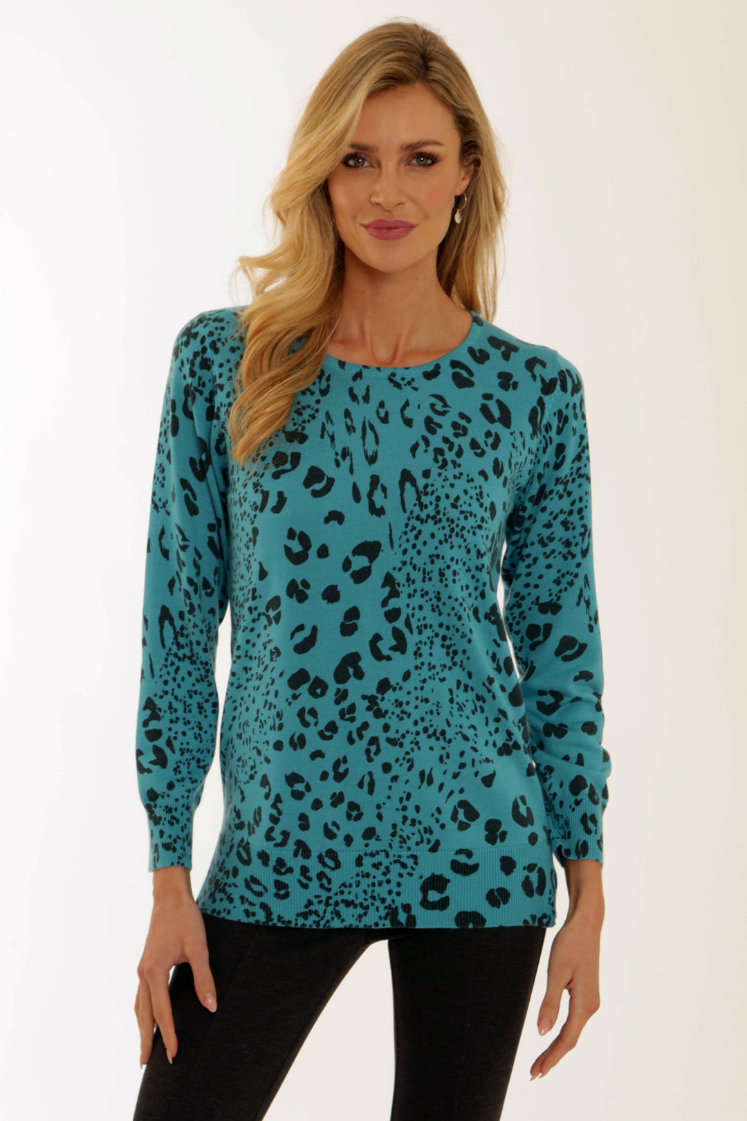 Woman wearing a turquoise leopard print top against a white background