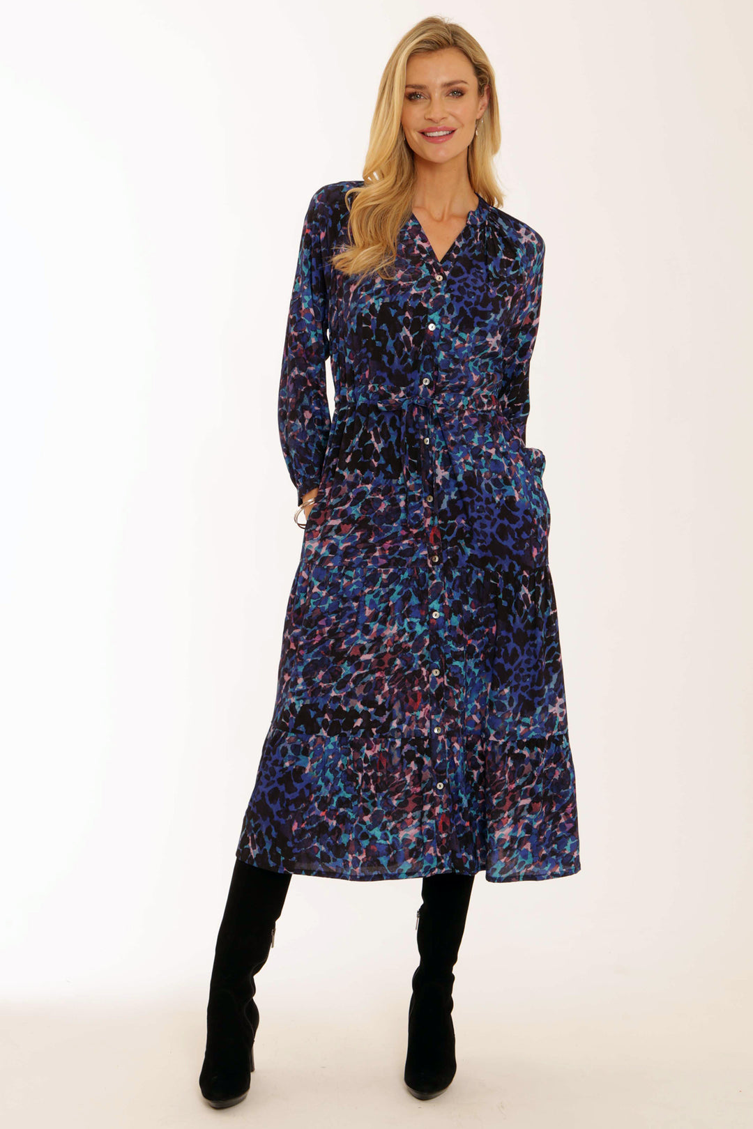 Woman wearing a long, patterned dress on a white background